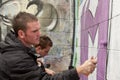 Teen boy concentrating on painting graffiti