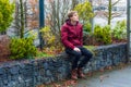 Teen boy dreaming about future ideas, visions and plans expecting good future sitting outdoor in city park