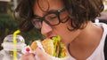 Teen boy eating hamburger and french fries in outdoor cafe. close-up Royalty Free Stock Photo