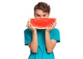 Teen boy eating watermelon