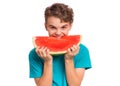 Teen boy eating watermelon