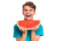 Teen boy eating watermelon