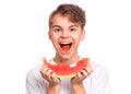 Teen boy eating watermelon