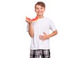 Teen boy eating watermelon