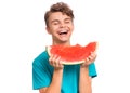 Teen boy eating watermelon