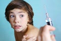 Teen boy in fear of injection. Royalty Free Stock Photo