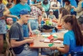 Teen boy and girl participating at origami workshop