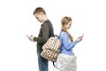 Teen boy and girl standing with mobile phones