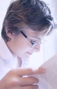 Teen boy in glasses reads a book Royalty Free Stock Photo