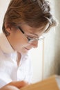 Teen boy in glasses reads a book Royalty Free Stock Photo