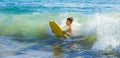 Teen boy has fun surfing in the waves Royalty Free Stock Photo