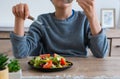 A teen boy having colorful salad for snack. Vegetable is healthy snack for children to have balancing healthy lifestyle.