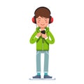 Teen boy in headphones listening to music on phone