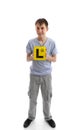 Teen boy holding L learner plates