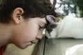 Teen boy kiss cat sleeping on the car Royalty Free Stock Photo