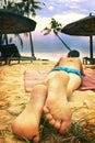 Teen boy lay on beach feet out Royalty Free Stock Photo