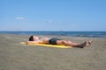 Teen boy lies on yellow towel and sunbathes on the beach. Traveling on an airplane with children. Concep