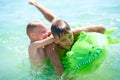 Teen boy and little boy play in water