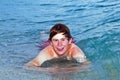 Teen boy lying on the waterfront of the ocean Royalty Free Stock Photo