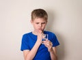 Boy observing a half full or half empty glass of water. Royalty Free Stock Photo