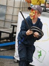 Teen boy with a painted under hero comic book marvel iron man face playing in the Playground municipal Park