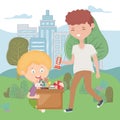 Teen and boy in the park with box full toys