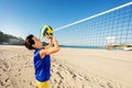 Teen boy passing ball playing beach volleyball Royalty Free Stock Photo