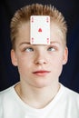 Teen Boy with Playing Card Stuck to Forehead Royalty Free Stock Photo