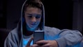 Teen boy playing viral game on smartphone, procrastination, gadget addiction