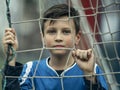 A teen boy portrait near the gate on the football field. Royalty Free Stock Photo