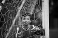 A teen boy portrait near the gate on the football field. Royalty Free Stock Photo