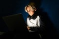 Teen boy programming or studying online on laptop.