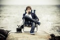 Teen Boy Relaxing at the Seaside with Old Phone