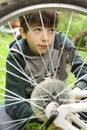 teen boy repair tire on bicycle Royalty Free Stock Photo