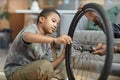 Teen boy repairing bicycle wheel Royalty Free Stock Photo