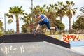 Teen boy rides his scooter at the skate park Royalty Free Stock Photo