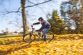 Teen boy riding his dirt bike through autumn foliage Royalty Free Stock Photo