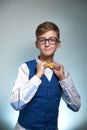 Teen boy shirt straightens bow-tie