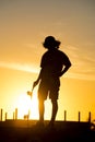 Teen boy silhouette with skateboard at sunset Royalty Free Stock Photo