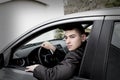 Teen Boy Sitting at Wheel of Car Royalty Free Stock Photo