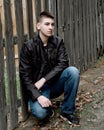 Teen Boy Sitting by Wooden Fence Royalty Free Stock Photo