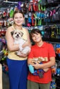 Boy with mother choosing dog treats for their puppy Royalty Free Stock Photo