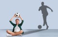 Teen boy with soccer ball dreaming about football player career Royalty Free Stock Photo