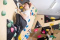 Teen guy practicing rock climbing on climbing wall Royalty Free Stock Photo