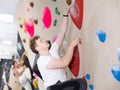 Teen guy practicing rock climbing on climbing wall Royalty Free Stock Photo