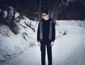 Teen Boy Standing on a Snow-Covered Road