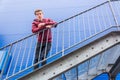 Teen boy standing on stairs of emergency exit