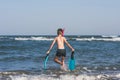 Teen boy in the swim flippers snorkeling mask and tude in the sea wave