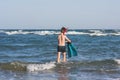 Teen boy in the swim flippers snorkeling mask and tude in the sea wave