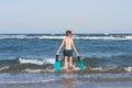 Teen boy in the swim flippers snorkeling mask and tude in the sea wave